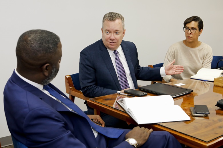 Minister Wayne Caines with President and Chief Executive Officer, John Huff and Director of Policy and Regulation, Suzanne Williams of ABIR. 