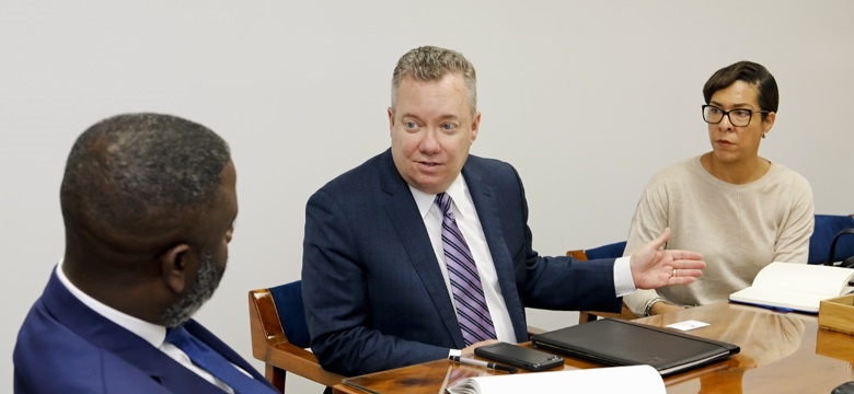 Minister Wayne Caines with President and Chief Executive Officer, John Huff and Director of Policy and Regulation, Suzanne Williams of ABIR.